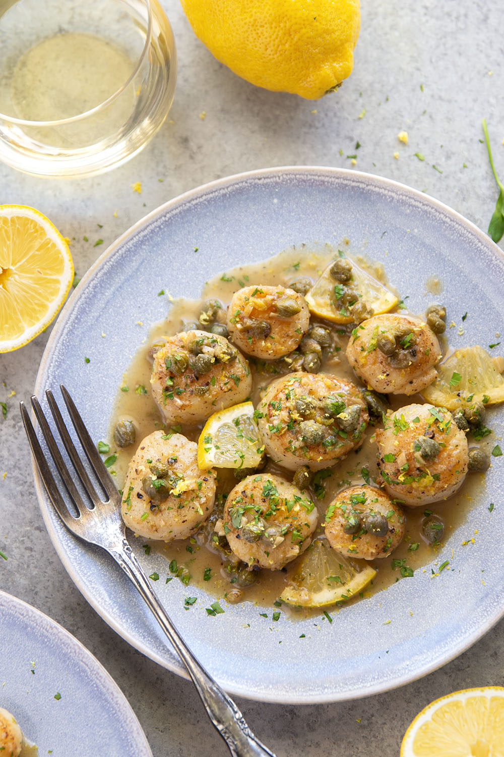 Buttery tender seared scallops with lemon caper sauce have the perfect level of fresh lemon flavor coupled with tangy capers and lots of fresh herbs on top.
