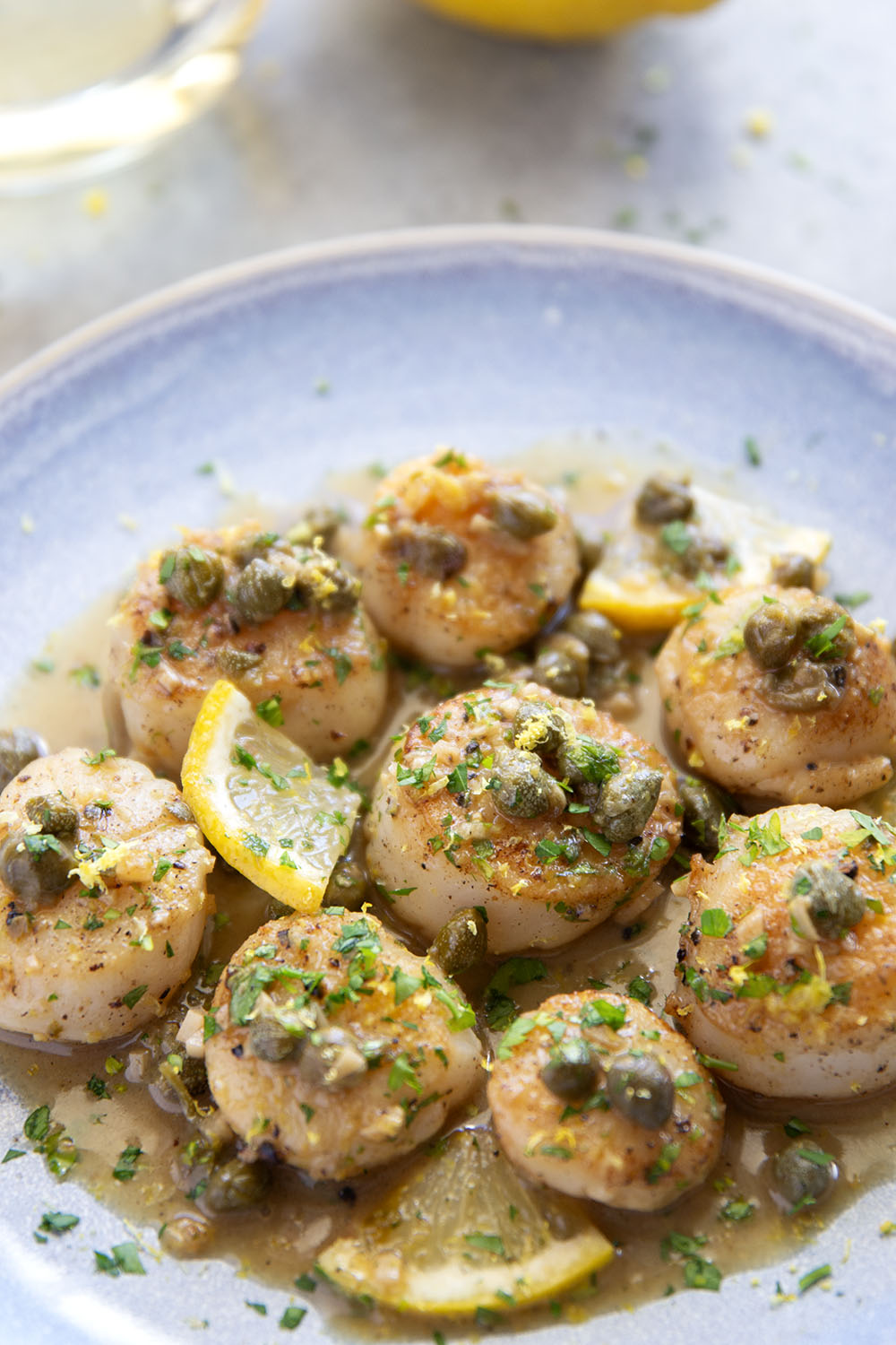 Buttery tender seared scallops with lemon caper sauce have the perfect level of fresh lemon flavor coupled with tangy capers and lots of fresh herbs on top.