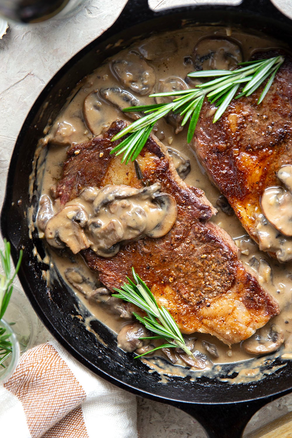Learn how to cook a perfect restaurant-style ribeye steak with mushroom sauce with this keeper recipe. The steak sears up buttery tender every time and is fantastic with a creamy stout mushroom sauce draped over top.