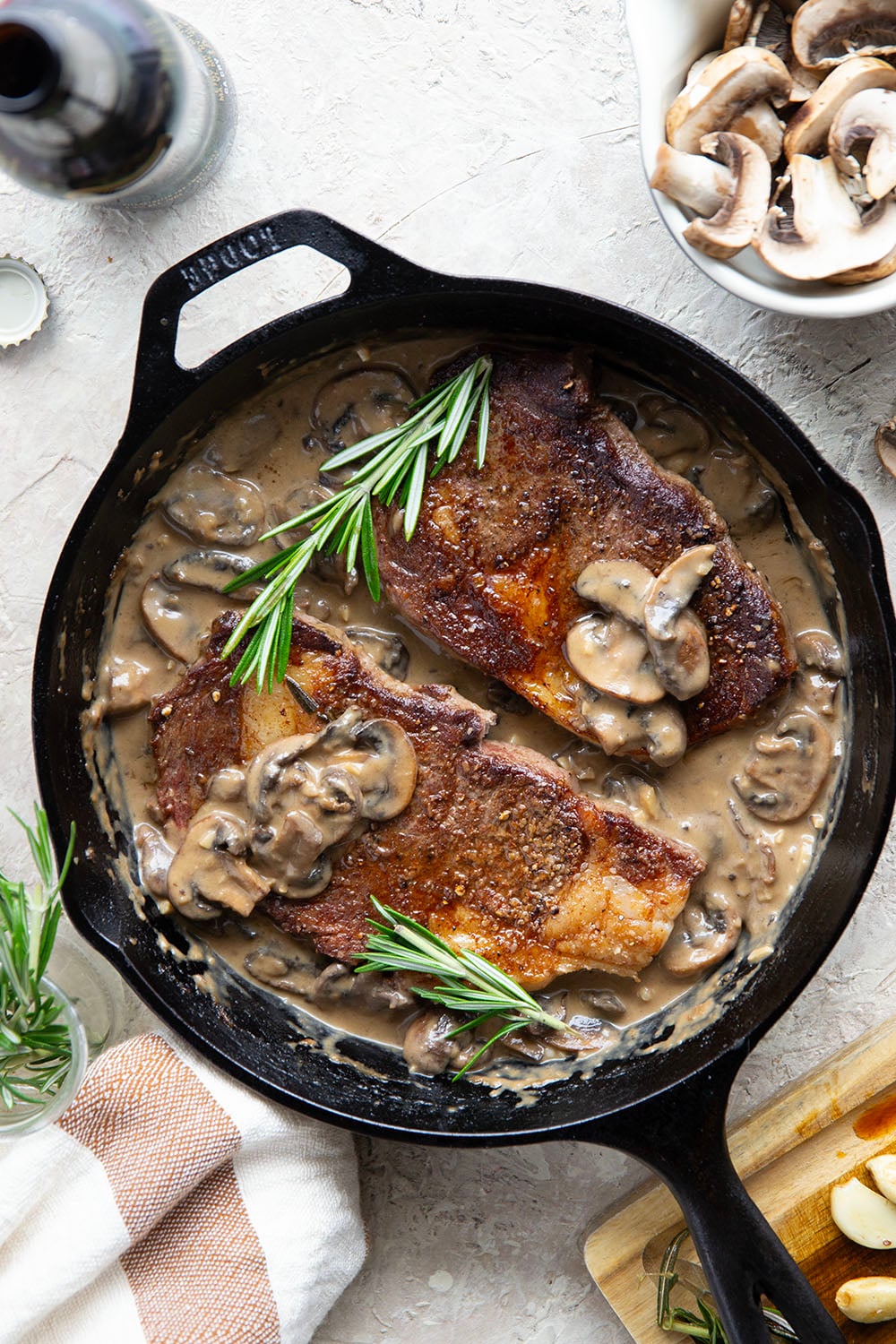 Learn how to cook a perfect restaurant-style ribeye steak with mushroom sauce with this keeper recipe. The steak sears up buttery tender every time and is fantastic with a creamy stout mushroom sauce draped over top.