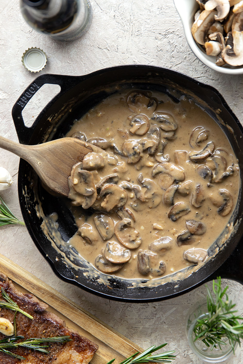 Learn how to cook a perfect restaurant-style ribeye steak with mushroom sauce with this keeper recipe. The steak sears up buttery tender every time and is fantastic with a creamy stout mushroom sauce draped over top.