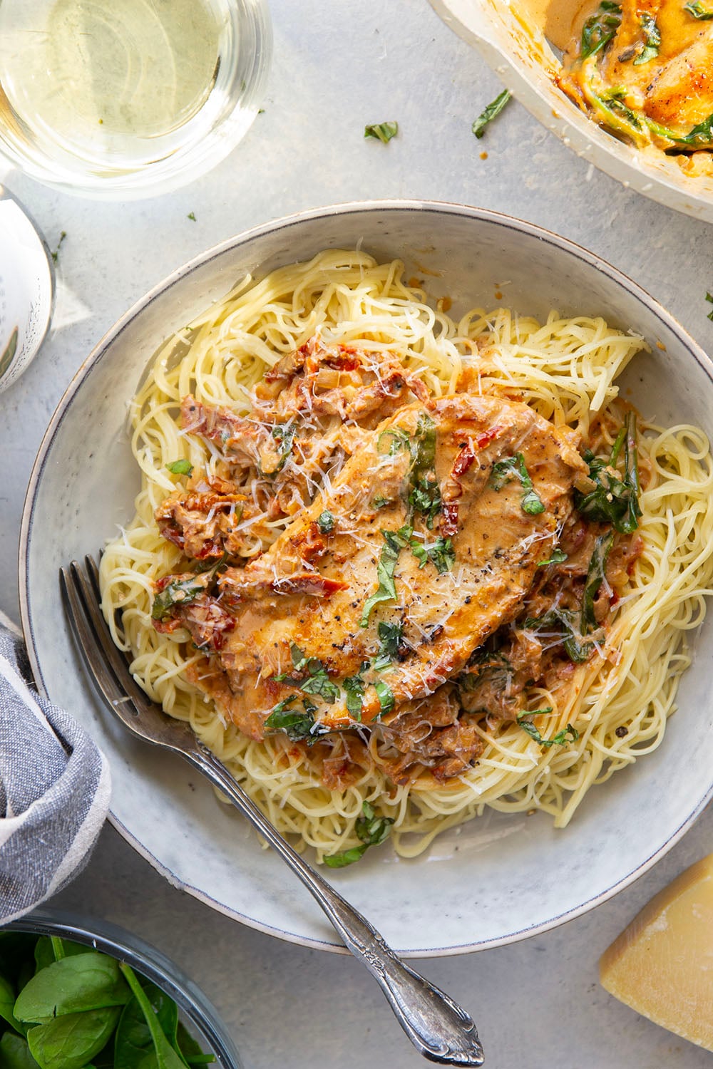 Flavorful white wine and tender sun-dried tomatoes make for a luxuriously creamy sauce in this white wine sun-dried tomato chicken that comes together in minutes and is fantastic served over angel hair.