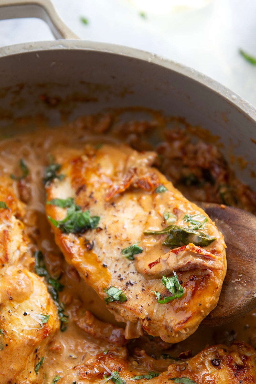 Flavorful white wine and tender sun-dried tomatoes make for a luxuriously creamy sauce in this white wine sun-dried tomato chicken that comes together in minutes and is fantastic served over angel hair.