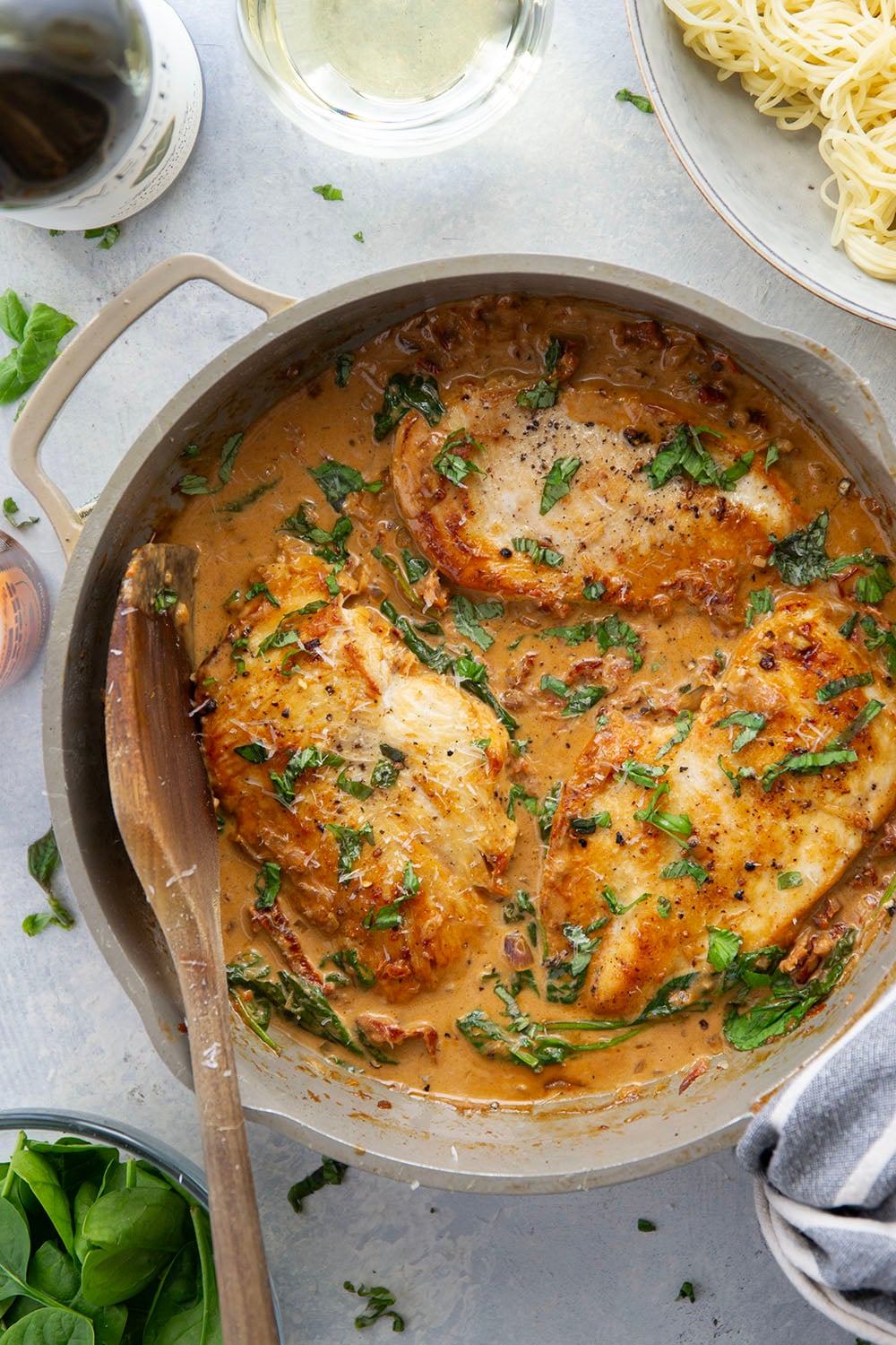 Flavorful white wine and tender sun-dried tomatoes make for a luxuriously creamy sauce in this white wine sun-dried tomato chicken that comes together in minutes and is fantastic served over angel hair.