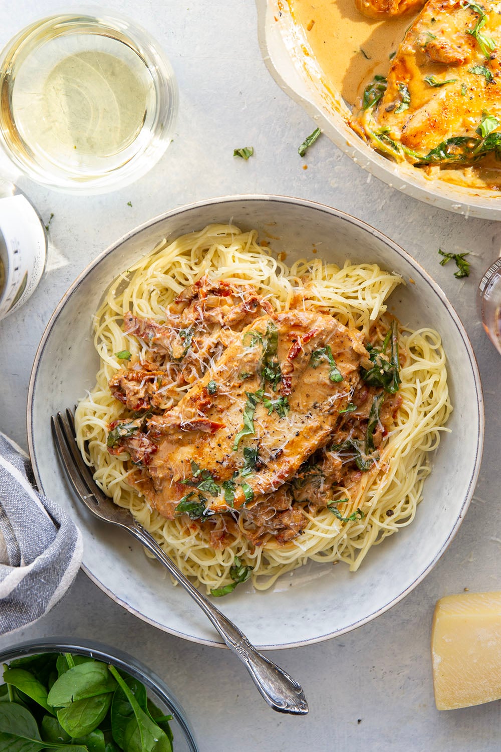 Flavorful white wine and tender sun-dried tomatoes make for a luxuriously creamy sauce in this white wine sun-dried tomato chicken that comes together in minutes and is fantastic served over angel hair.