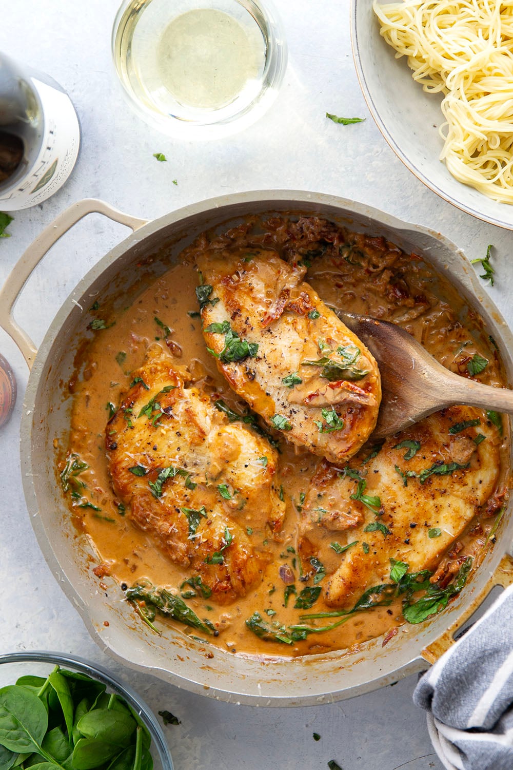 Flavorful white wine and tender sun-dried tomatoes make for a luxuriously creamy sauce in this white wine sun-dried tomato chicken that comes together in minutes and is fantastic served over angel hair.