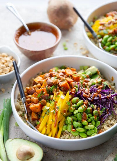 These sweet potato chickpea bowls feature tender roasted sweet potatoes and chickpeas piled on a base of steamed quinoa with lots of fresh veggies, sweet mango, and a drizzle of flavorful Thai peanut butter sauce.
