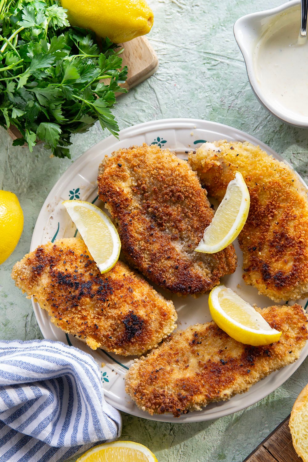 This chicken piccata sandwich feature all the things you love about classic chicken piccata in sandwich form! Fluffy brioche buns with crispy chicken cutlets squeezed with fresh lemon, tangy capers, peppery argula, and a creamy lemon aioli.