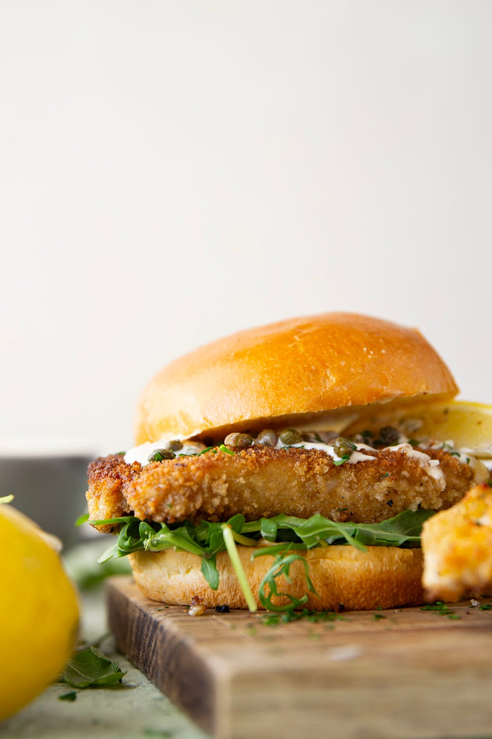 This chicken piccata sandwich feature all the things you love about classic chicken piccata in sandwich form! Fluffy brioche buns with crispy chicken cutlets squeezed with fresh lemon, tangy capers, peppery argula, and a creamy lemon aioli.