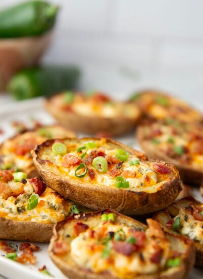 Everything you love about jalapeno poppers is packed into these jalapeno popper potato skins! The potatoes bake up incredibly crispy and are jam-packed with a spicy jalapeno cheddar filling and lots of crispy bacon on top.