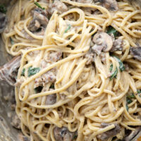 Tender sauteed mushrooms, sausage, and spinach spruce up this creamy sausage fettuccine alfredo into a luxurious pasta dinner.