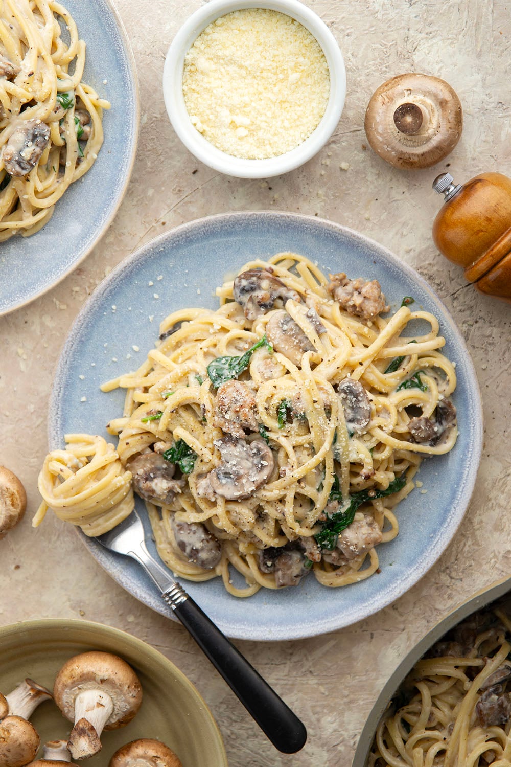 Tender sauteed mushrooms, sausage, and spinach spruce up this creamy sausage fettuccine alfredo into a luxurious pasta dinner.