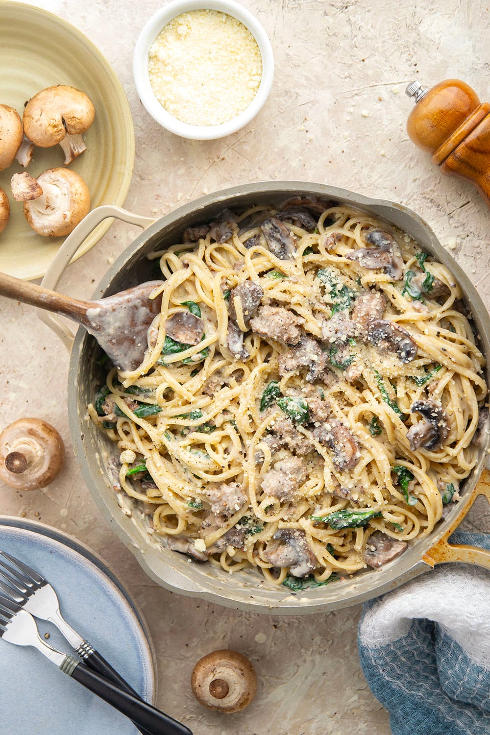 Tender sauteed mushrooms, sausage, and spinach spruce up this creamy sausage fettuccine alfredo into a luxurious pasta dinner.