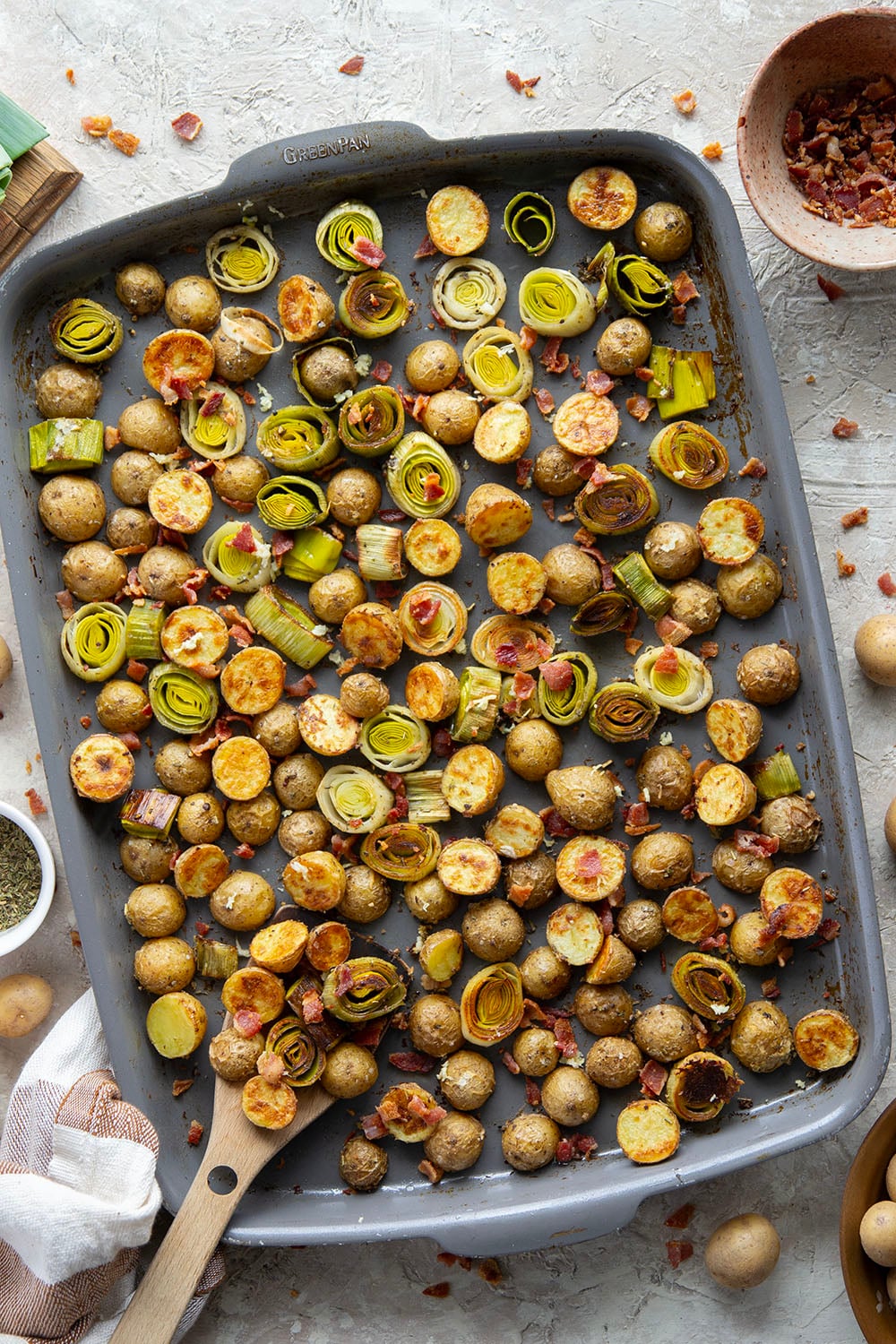 Roasted in flavorful bacon drippings until perfectly crispy and tender and tossed with crisp bacon bits, these roasted potatoes and leeks are the easiest side dish that goes well with any meal.
