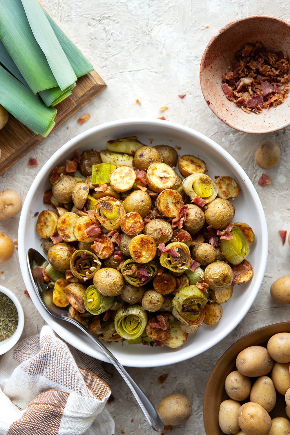 Roasted in flavorful bacon drippings until perfectly crispy and tender and tossed with crisp bacon bits, these roasted potatoes and leeks are the easiest side dish that goes well with any meal.