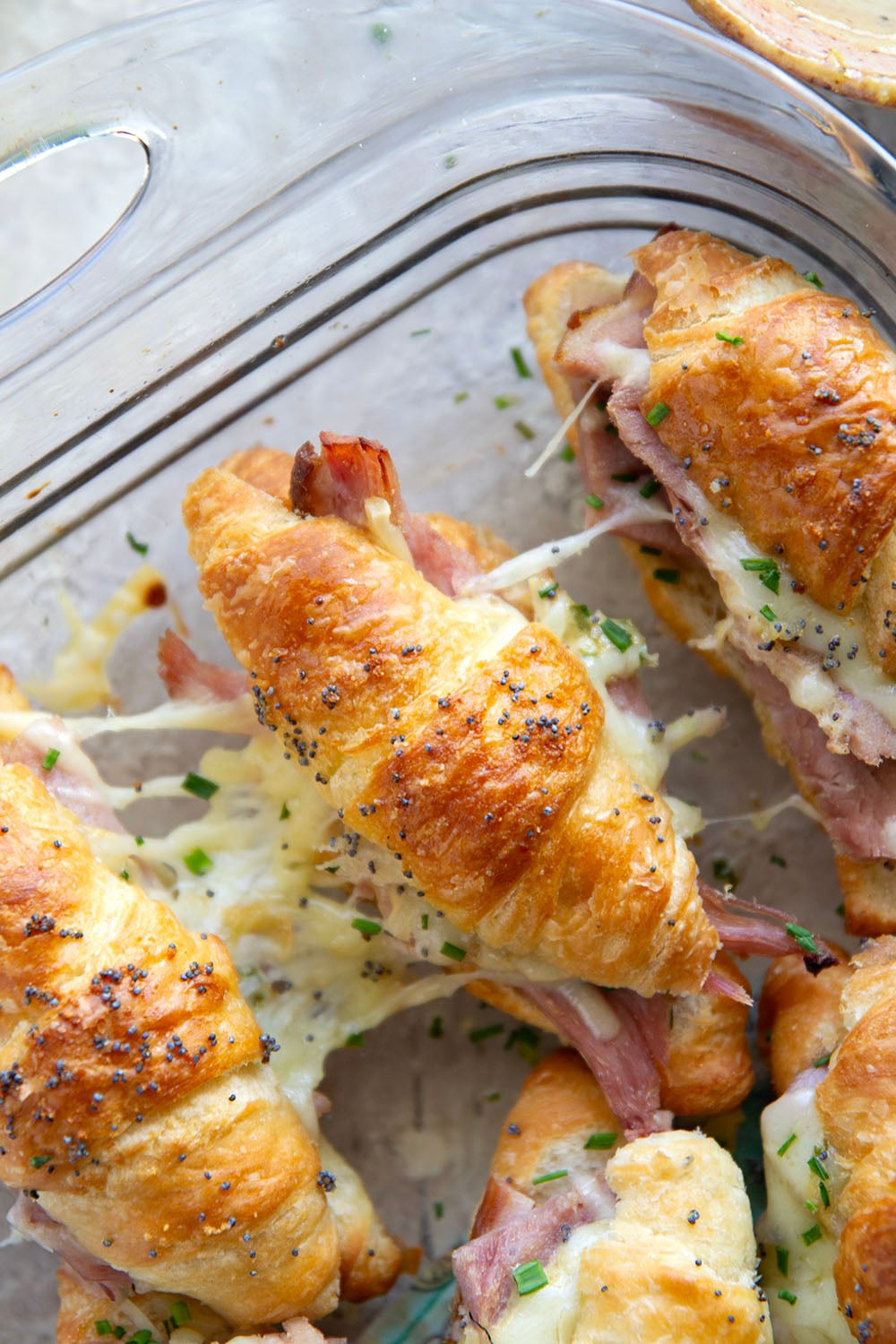 Gooey gruyere cheese, sliced deli ham, and a chive honey mustard spruce up classic ham and cheese croissant sliders into a winning appetizer that will disappear within minutes every time!