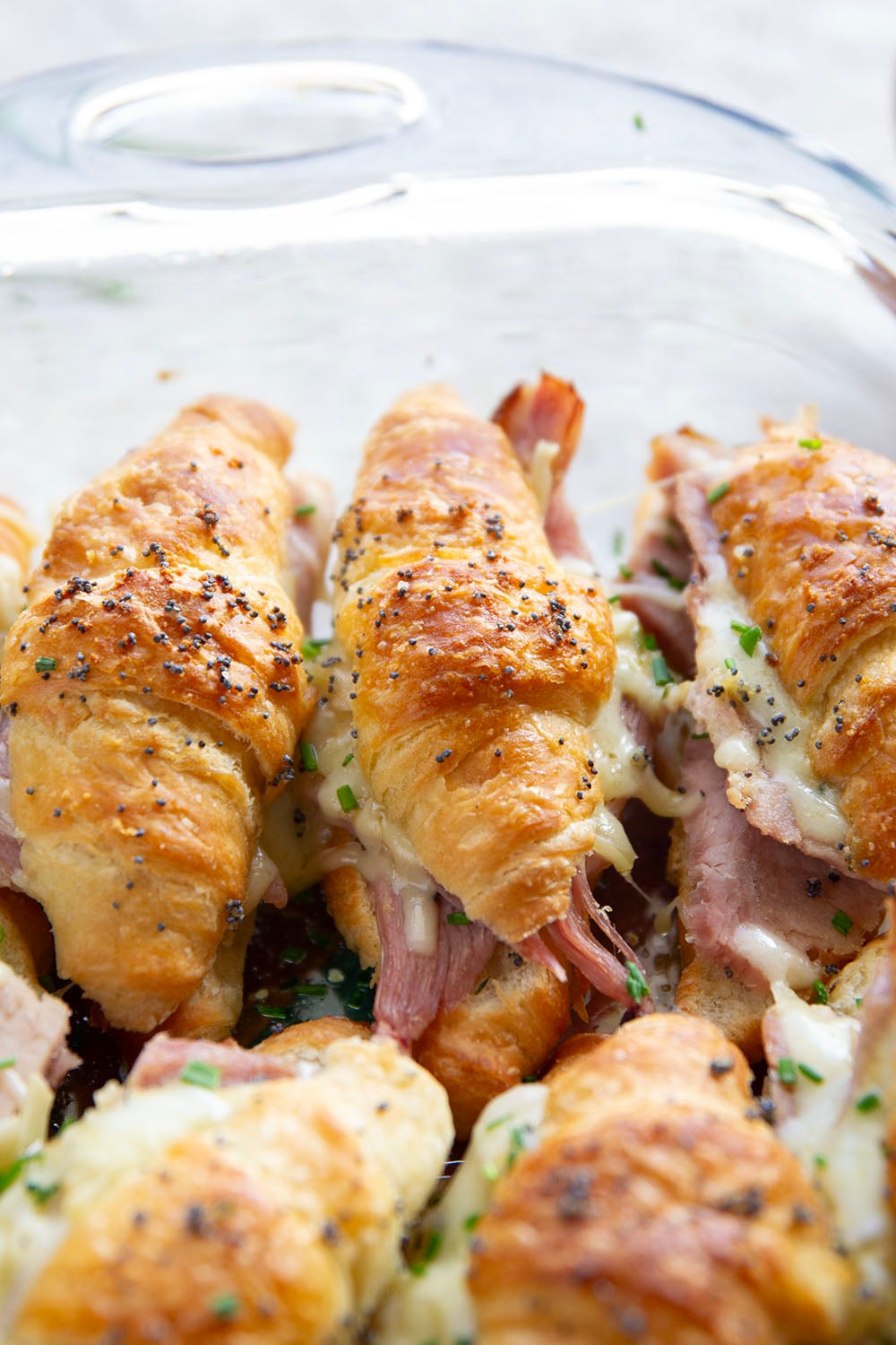 Gooey gruyere cheese, sliced deli ham, and a chive honey mustard spruce up classic ham and cheese croissant sliders into a winning appetizer that will disappear within minutes every time!