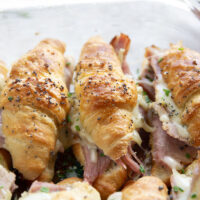 Gooey gruyere cheese, sliced deli ham, and a chive honey mustard spruce up classic ham and cheese croissant sliders into a winning appetizer that will disappear within minutes every time!