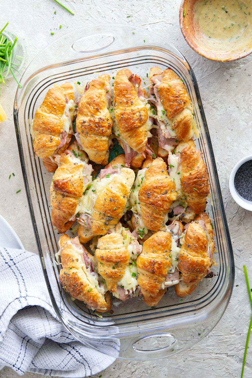 Gooey gruyere cheese, sliced deli ham, and a chive honey mustard spruce up classic ham and cheese croissant sliders into a winning appetizer that will disappear within minutes every time!