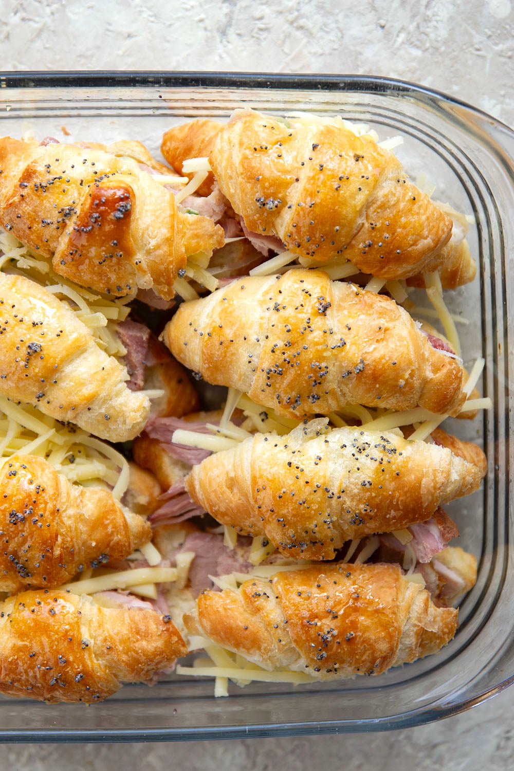 Gooey gruyere cheese, sliced deli ham, and a chive honey mustard spruce up classic ham and cheese croissant sliders into a winning appetizer that will disappear within minutes every time!