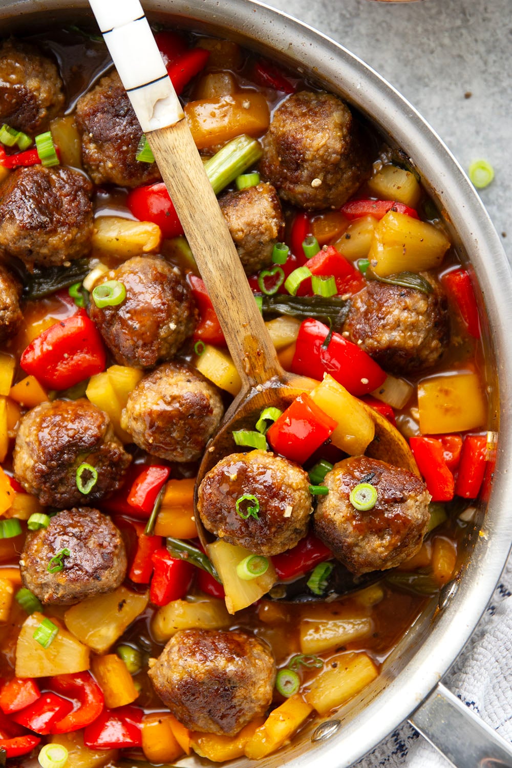 A homemade sweet and sour sauce coats every inch of these juicy sweet and sour meatballs that cook up with colorful peppers and sweet pineapple all in one pan.