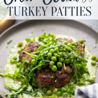 Juicy seared turkey patties are served on an herby green goddess sauce with lots of fresh arugula pea salad piled on top for a super fresh spring dinner.