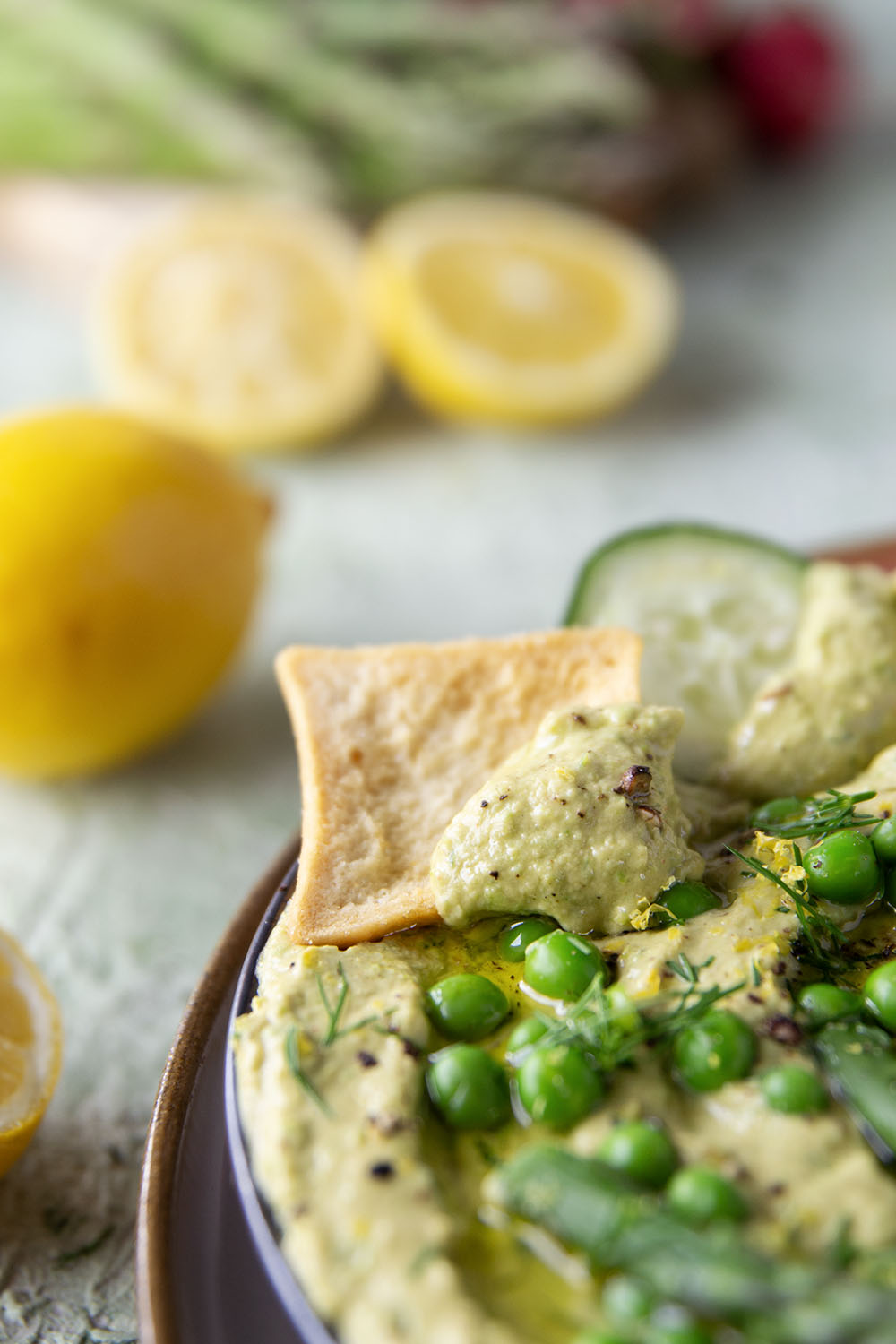 Vibrant spring peas and asparagus are the best spring twist on hummus! This asparagus pea hummus is silky smooth and pairs wonderfully with fresh vegetables and pita chips for dipping.