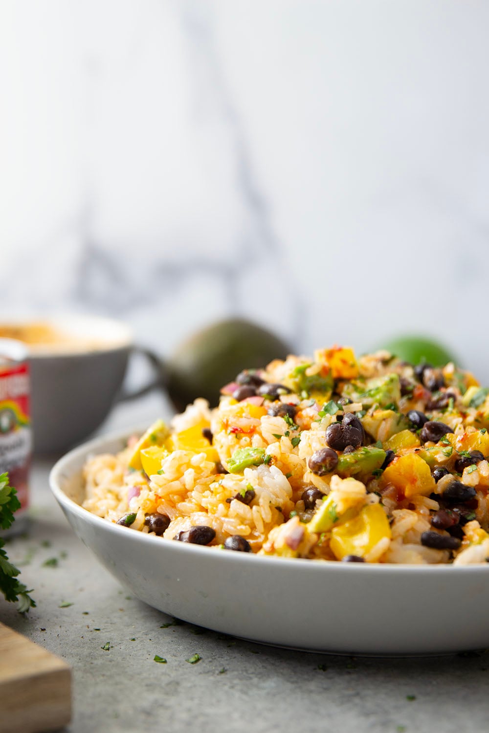 This black bean rice salad features fluffy steamed rice with black beans, sweet peppers, and avocado dressed in a sweet and spicy honey chipotle dressing.