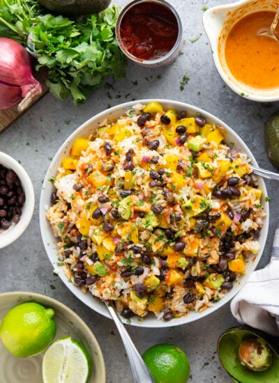 This black bean rice salad features fluffy steamed rice with black beans, sweet peppers, and avocado dressed in a sweet and spicy honey chipotle dressing.