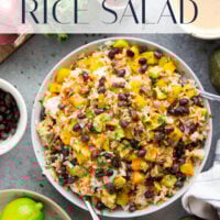 This black bean rice salad features fluffy steamed rice with black beans, sweet peppers, and avocado dressed in a sweet and spicy honey chipotle dressing.