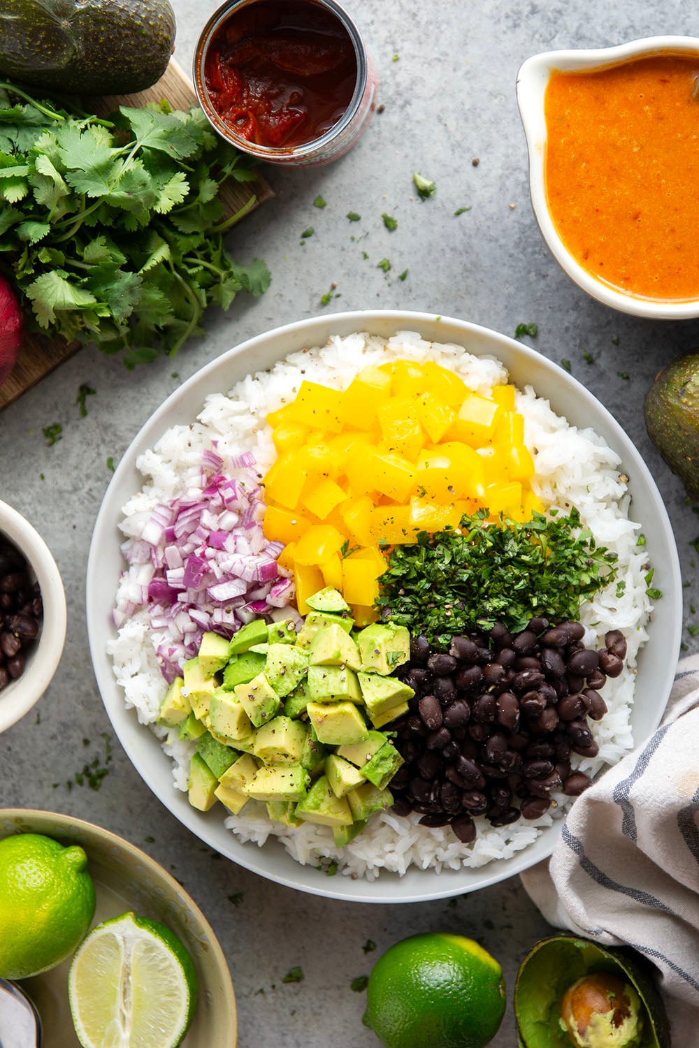 This black bean rice salad features fluffy steamed rice with black beans, sweet peppers, and avocado dressed in a sweet and spicy honey chipotle dressing.