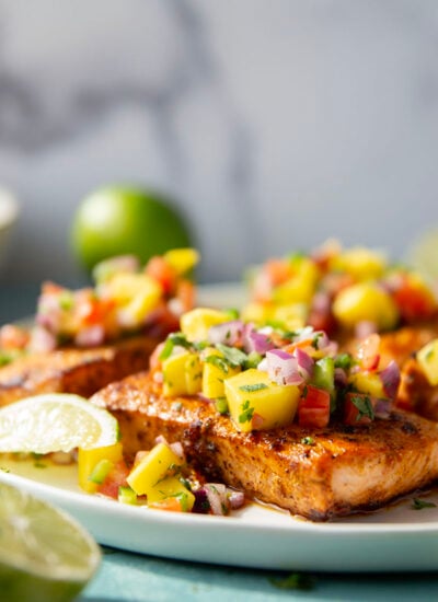 Marinated in a fresh lime and chili sauce, grilled to perfection, and topped with a super fresh mango salsa, this grilled chili lime salmon is an easy dinner that's full of flavor!