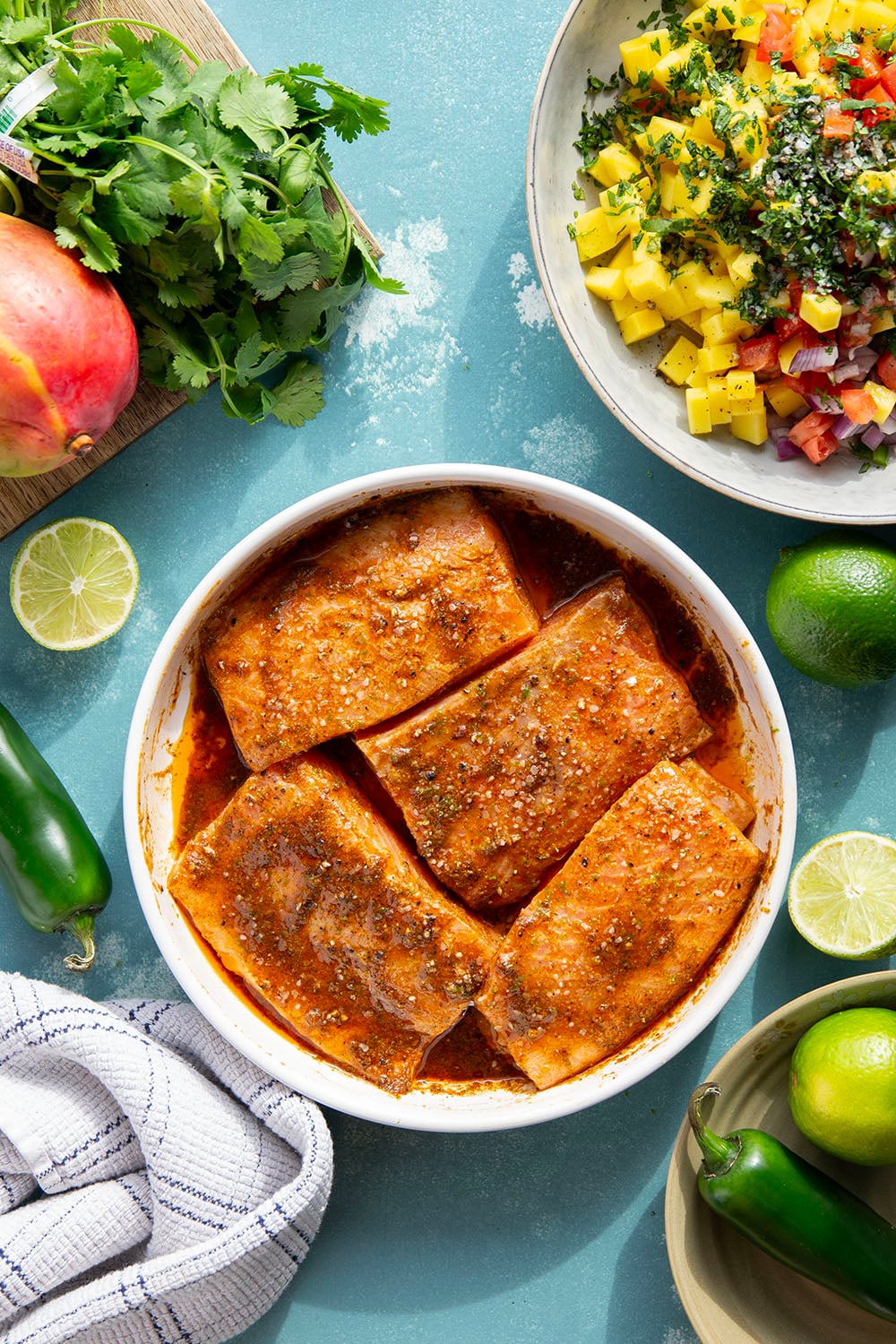 Marinated in a fresh lime and chili sauce, grilled to perfection, and topped with a super fresh mango salsa, this grilled chili lime salmon is an easy dinner that's full of flavor!