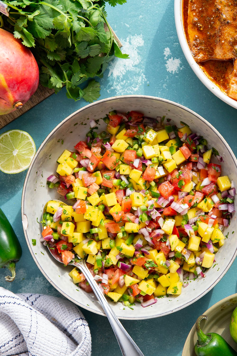 Marinated in a fresh lime and chili sauce, grilled to perfection, and topped with a super fresh mango salsa, this grilled chili lime salmon is an easy dinner that's full of flavor!