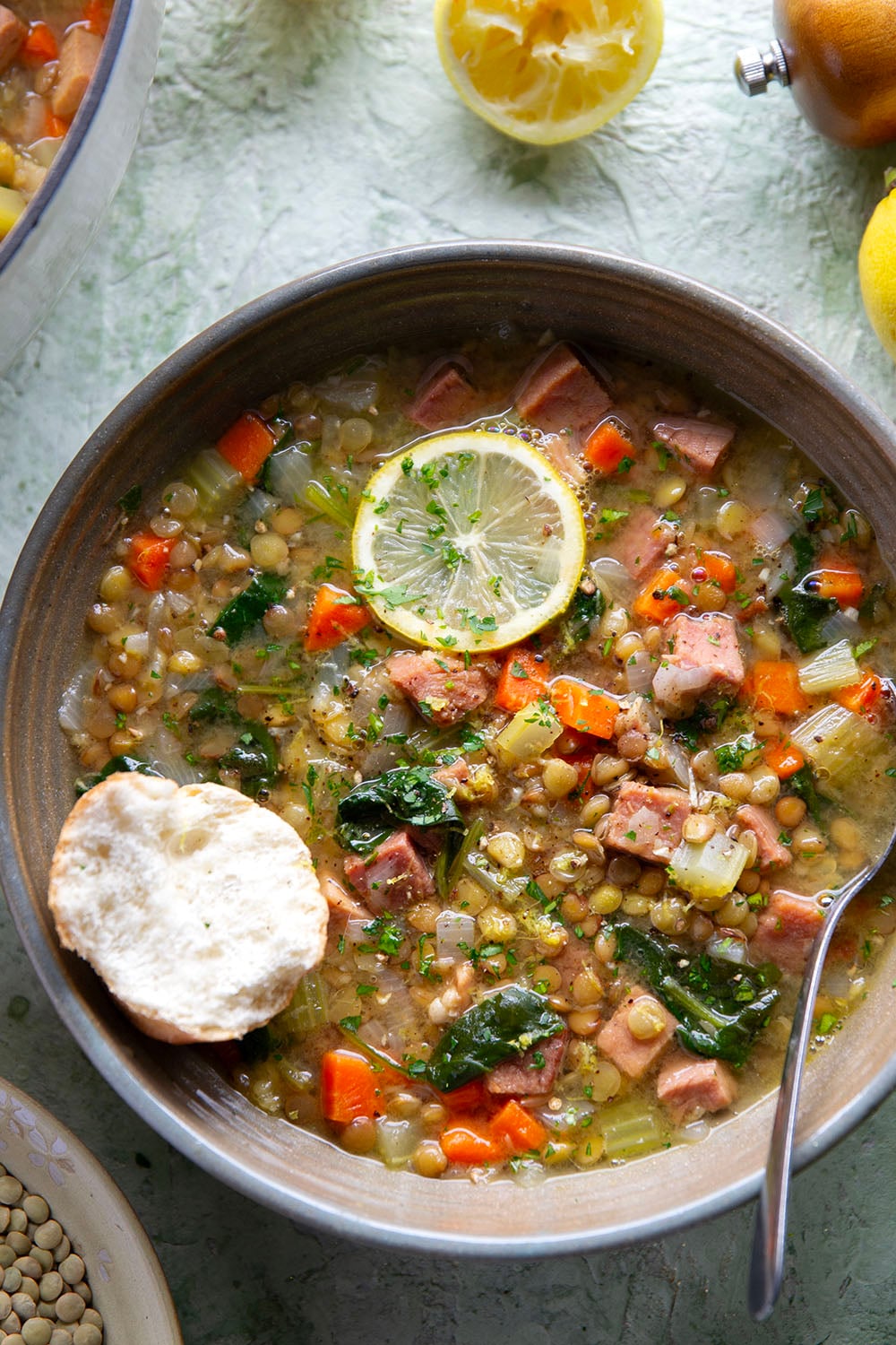 Tender lentils and lots of fresh lemon jazz up this hearty lentil ham soup that comes together all in one pot and is the best use for leftover ham!
