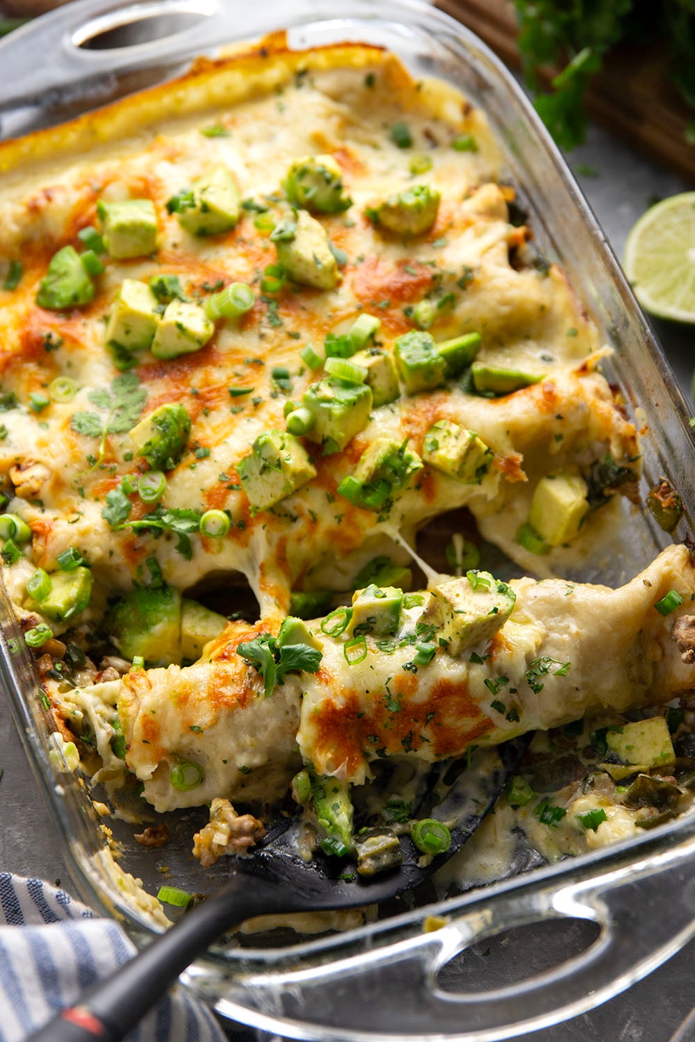 Flavorful poblanos and ground turkey make up a hearty filling in these ground turkey enchiladas that bake up with a cheesy white enchilada sauce on top and lots of toppings.