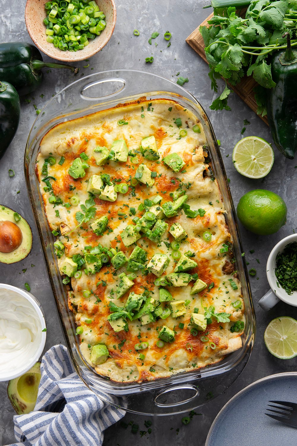 Flavorful poblanos and ground turkey make up a hearty filling in these ground turkey enchiladas that bake up with a cheesy white enchilada sauce on top and lots of toppings.