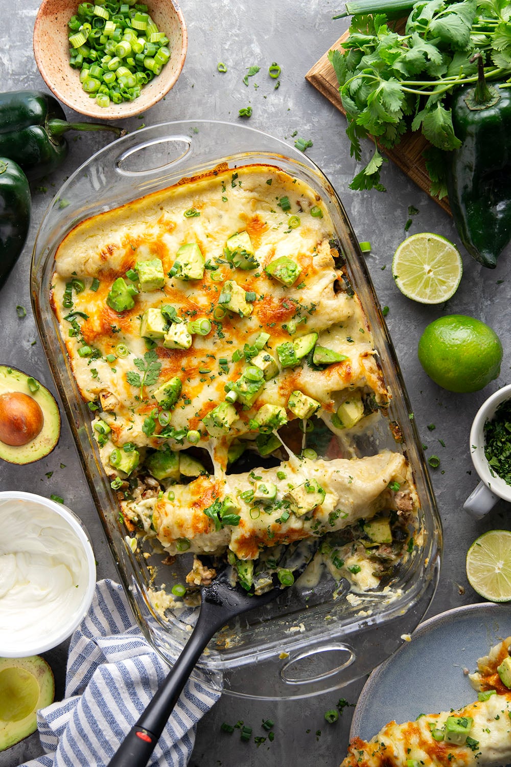Flavorful poblanos and ground turkey make up a hearty filling in these ground turkey enchiladas that bake up with a cheesy white enchilada sauce on top and lots of toppings.