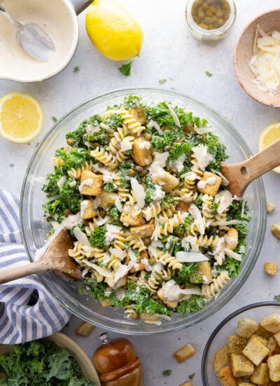 Packed with tender chopped kale, pasta, and all the caesar salad works including a homemade lemon caesar dressing, this kale caesar pasta salad will soon be a cookout staple for the summer.