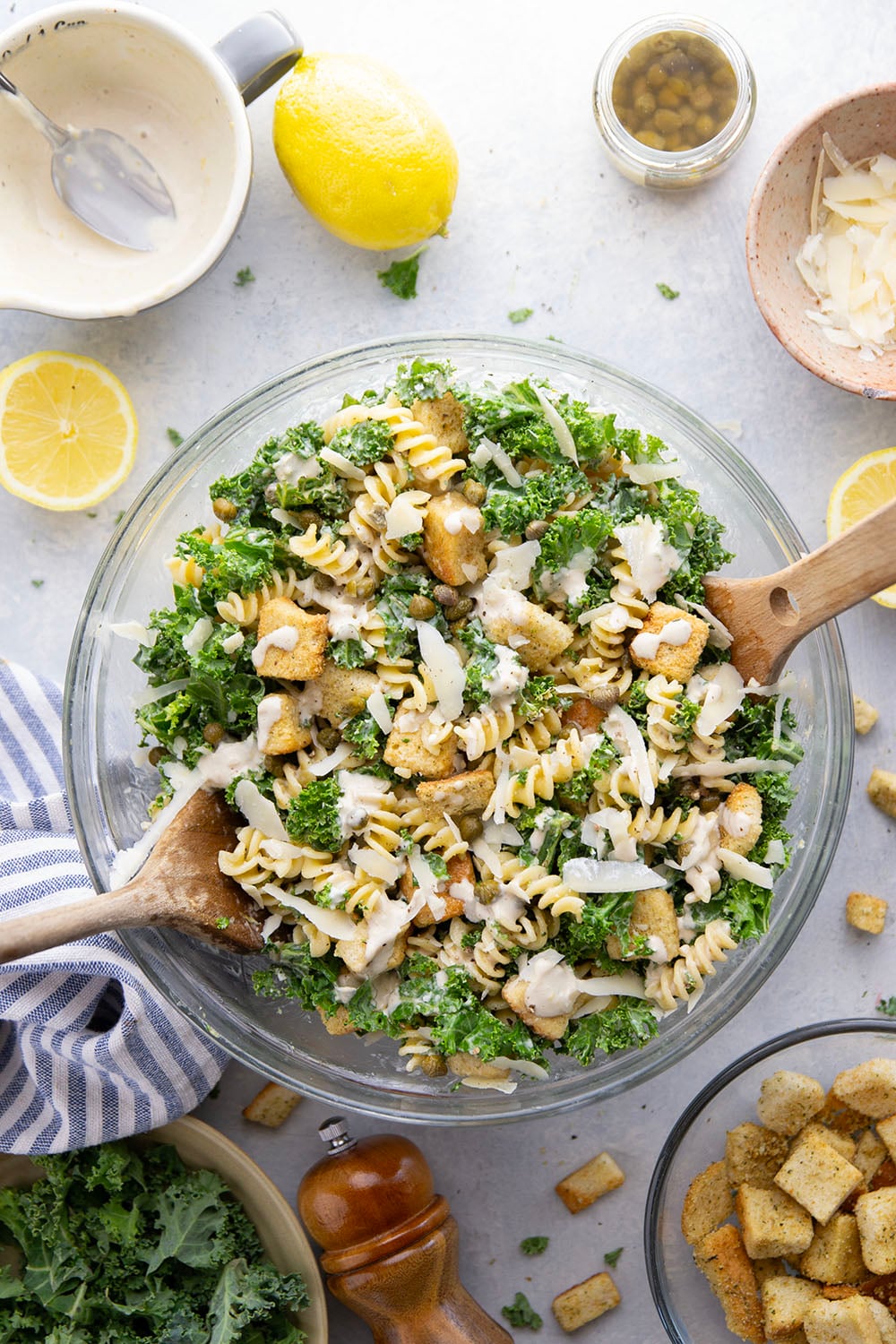 Packed with tender chopped kale, pasta, and all the caesar salad works including a homemade lemon caesar dressing, this kale caesar pasta salad will soon be a cookout staple for the summer.