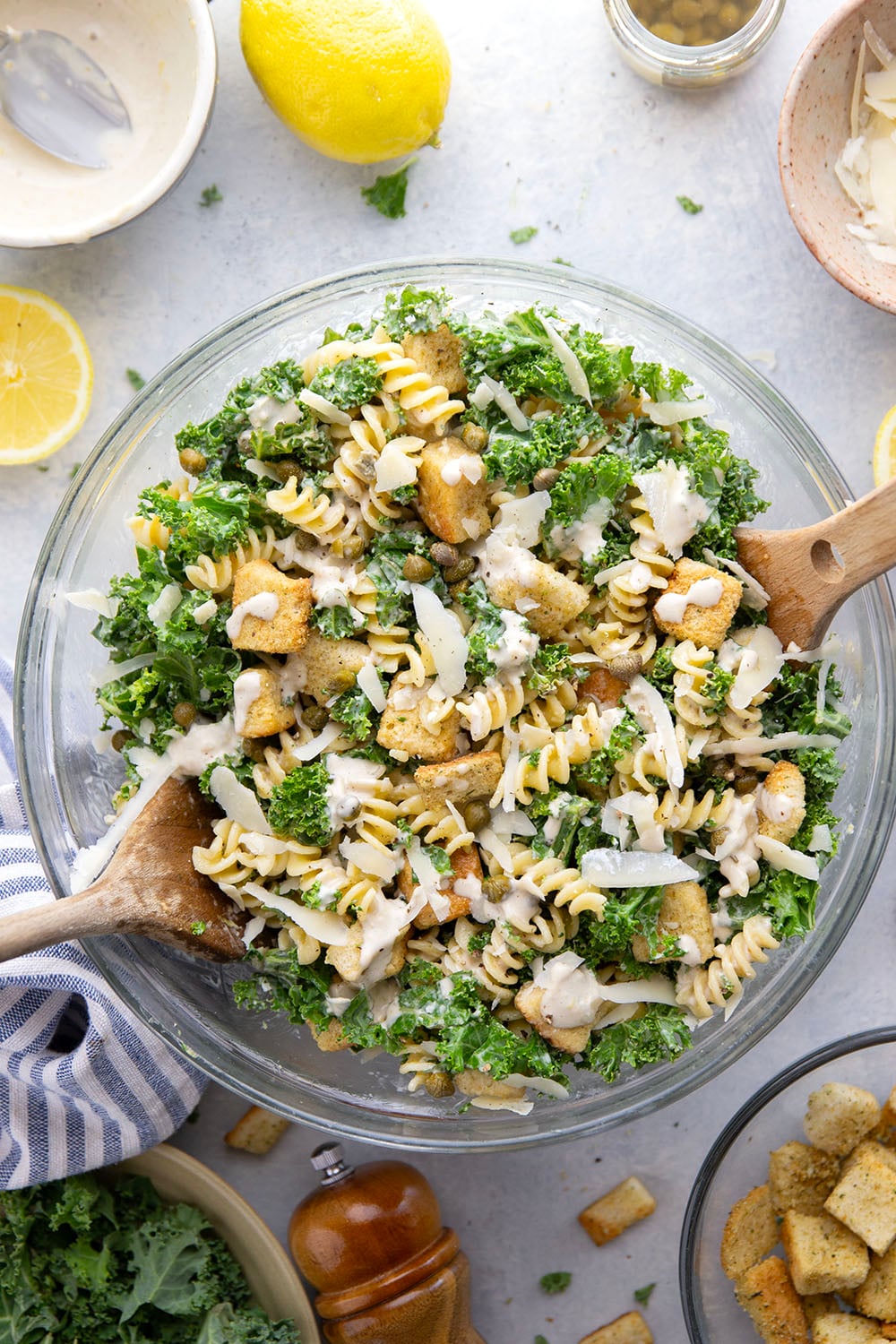 Packed with tender chopped kale, pasta, and all the caesar salad works including a homemade lemon caesar dressing, this kale caesar pasta salad will soon be a cookout staple for the summer.