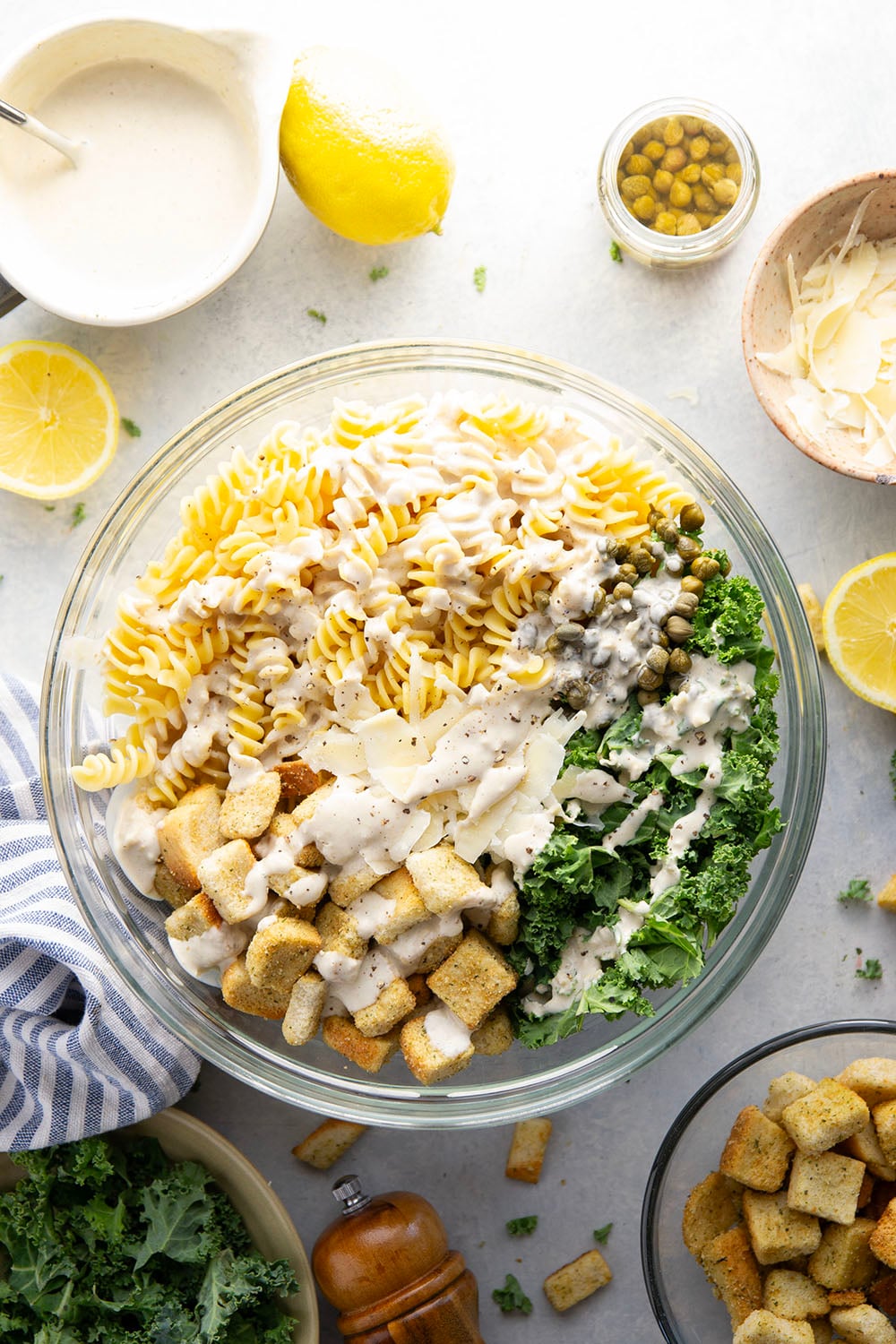 Packed with tender chopped kale, pasta, and all the caesar salad works including a homemade lemon caesar dressing, this kale caesar pasta salad will soon be a cookout staple for the summer.