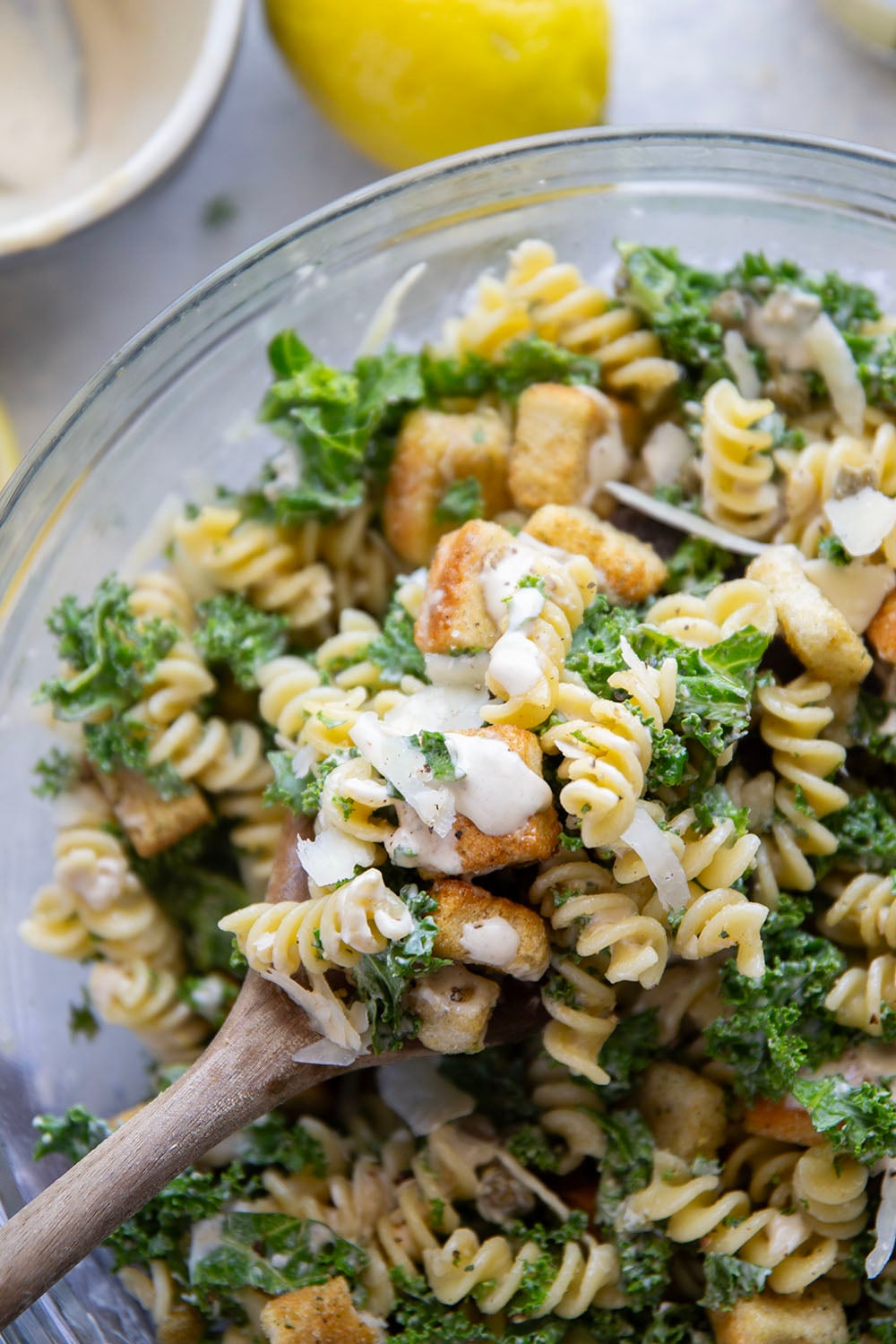 Packed with tender chopped kale, pasta, and all the caesar salad works including a homemade lemon caesar dressing, this kale caesar pasta salad will soon be a cookout staple for the summer.