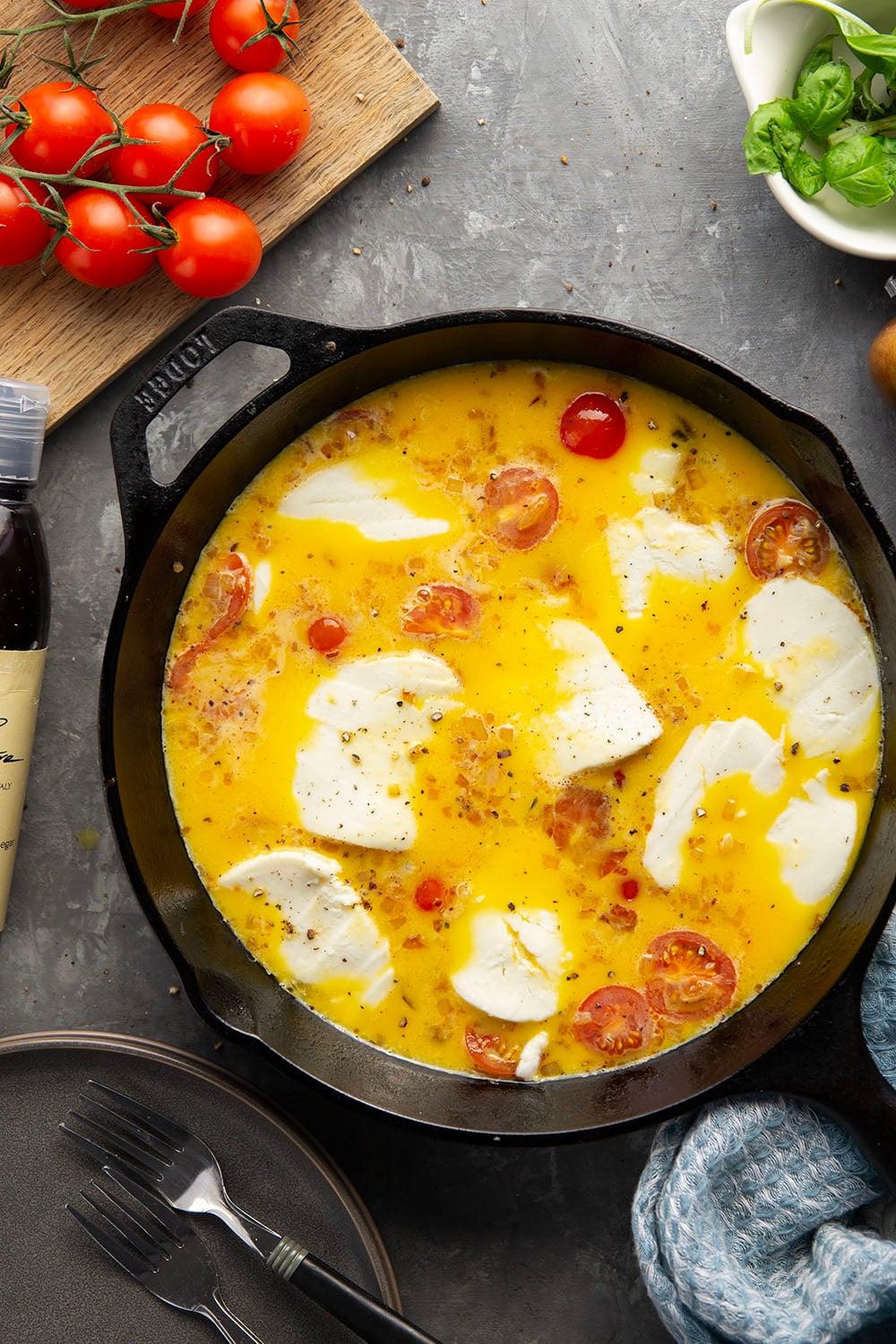 This caprese frittata couldn't be easier to whip up and feature a base of fluffy eggs, sweet cherry tomatoes, gooey fresh mozzarella, and lots of fresh basil and balsamic glaze on top.