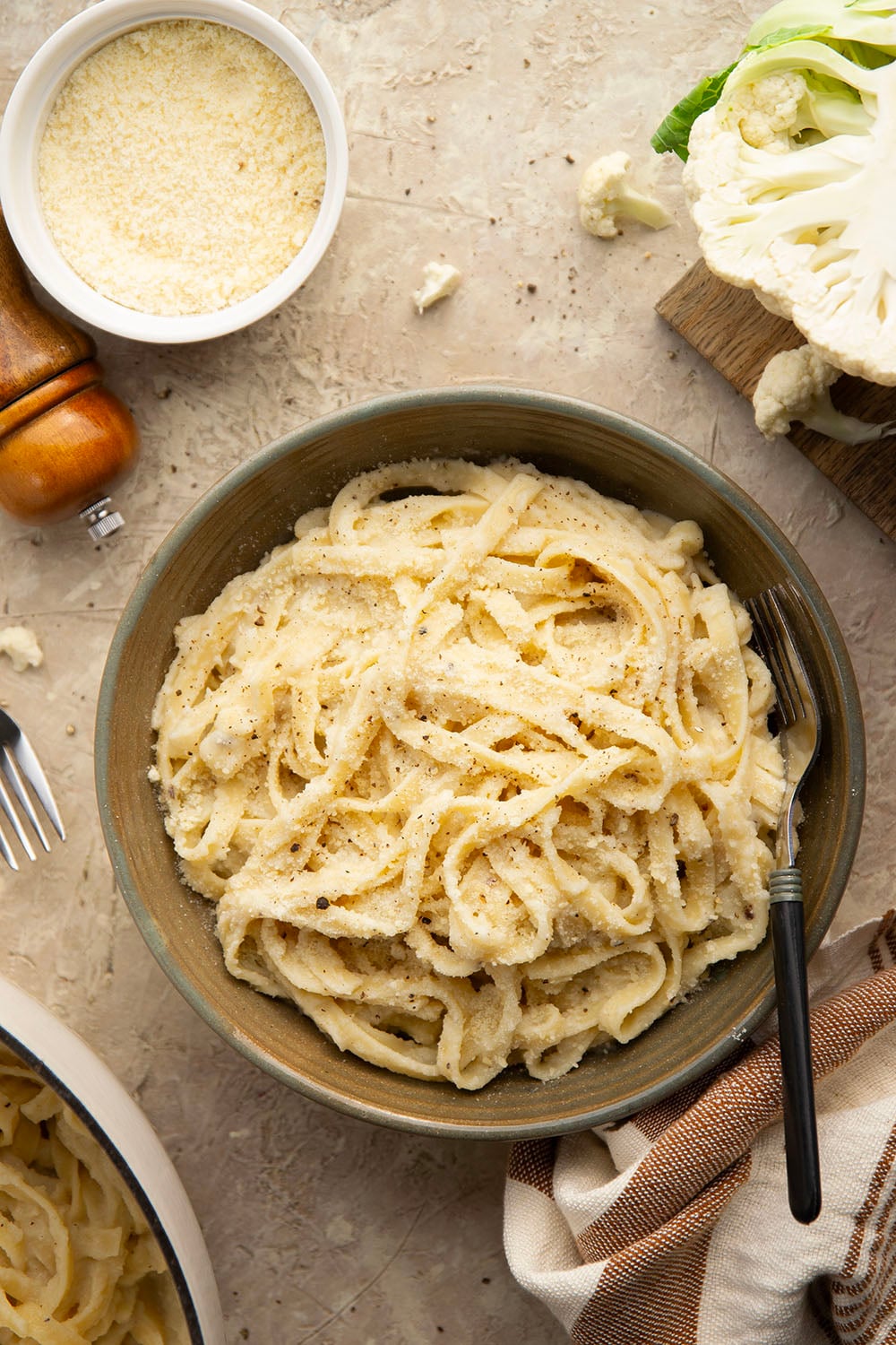 Indulge in a creamy, silky alfredo sauce for a fraction of the calories in this cauliflower alfredo sauce version! NO heavy cream needed and it's made in minutes on the stovetop.