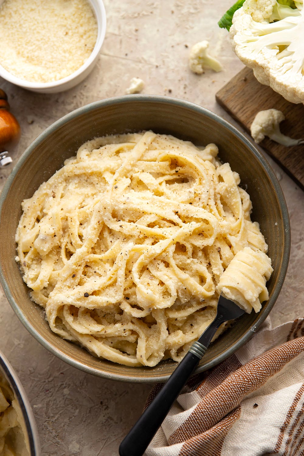 Indulge in a creamy, silky alfredo sauce for a fraction of the calories in this cauliflower alfredo sauce version! NO heavy cream needed and it's made in minutes on the stovetop.