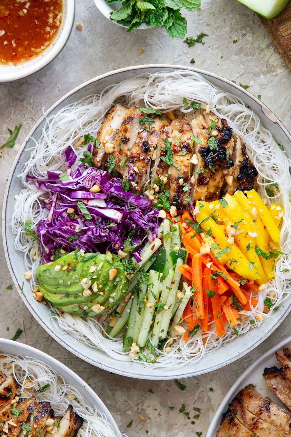 Lemongrass marinated grilled chicken and all the fresh spring roll ingredients collide in these colorful spring roll bowls. Easy to prep ahead for healthy lunches or dinners!