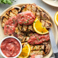 These grilled orange pork chops feature pork chops marinated in a fresh orange marinade, grilled until perfectly juicy, and served with a sweet and tangy rhubarb compote.