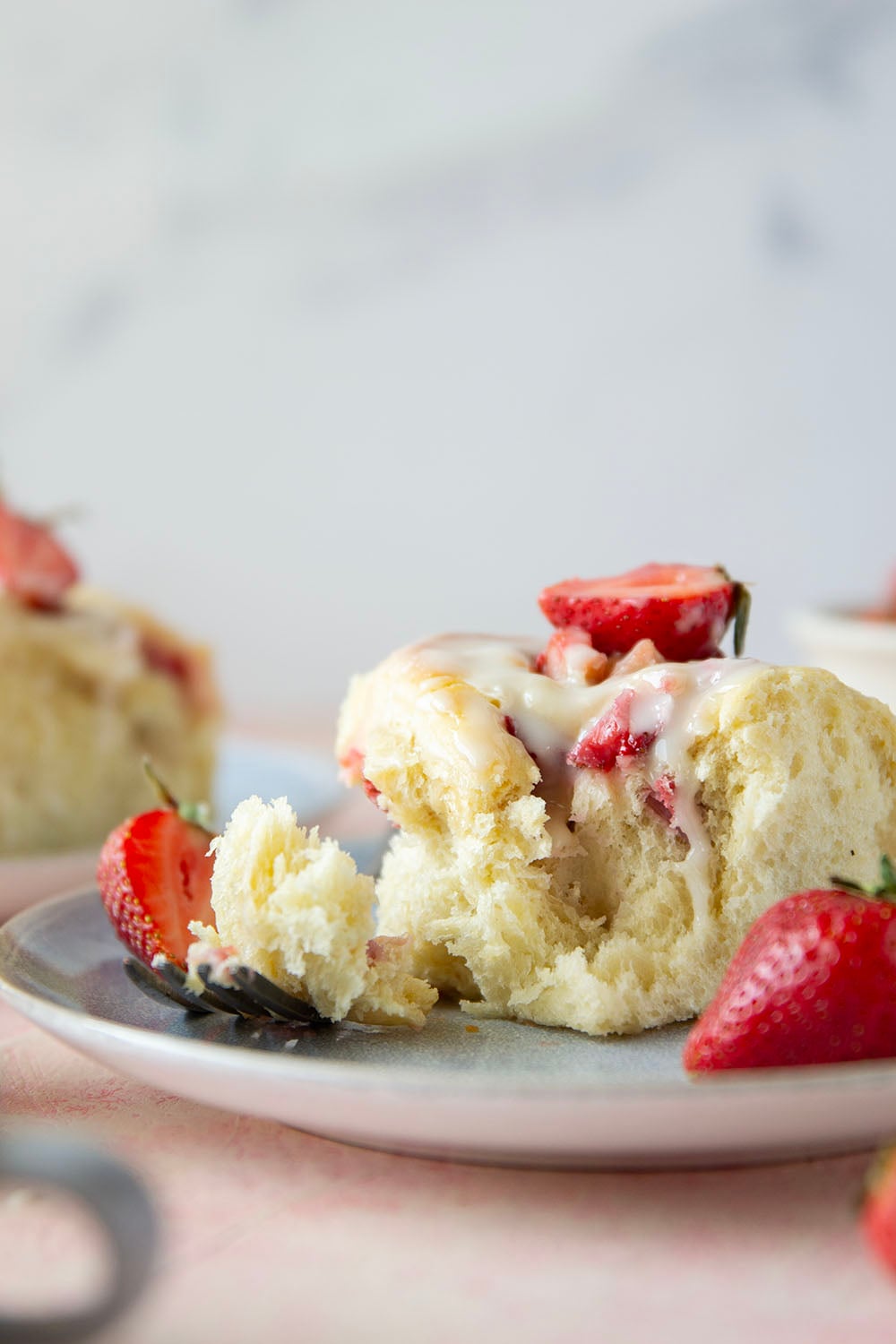 Melt-in-your-mouth fluffy sweet rolls are stuffed with a sweet and tangy rhubarb strawberry filling for the ultimate twist on strawberry sweet rolls!