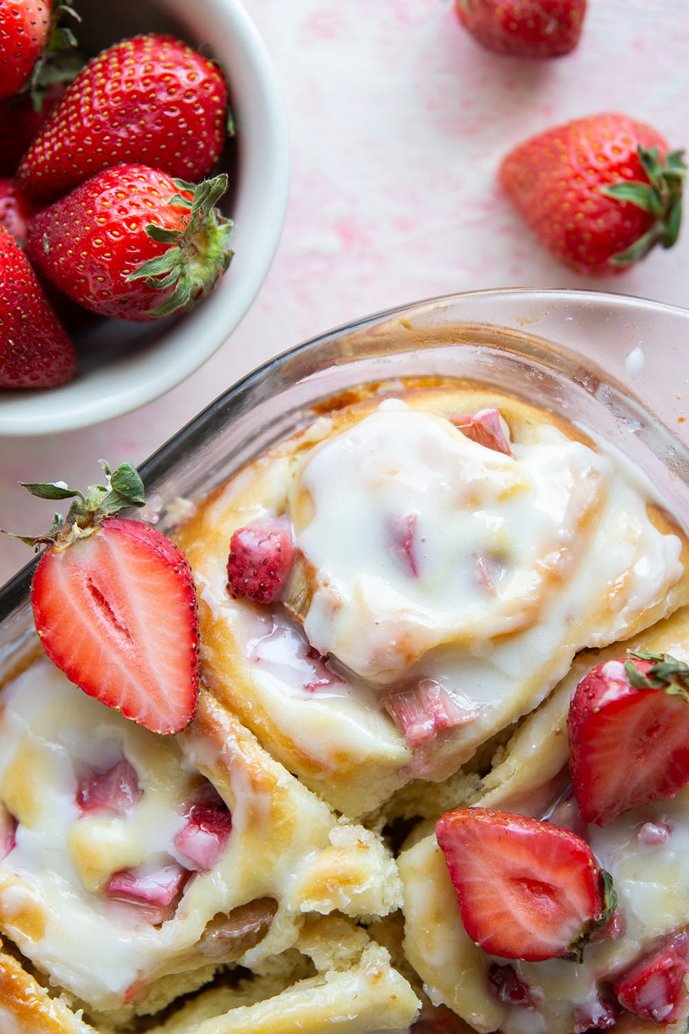 Melt-in-your-mouth fluffy sweet rolls are stuffed with a sweet and tangy rhubarb strawberry filling for the ultimate twist on strawberry sweet rolls!